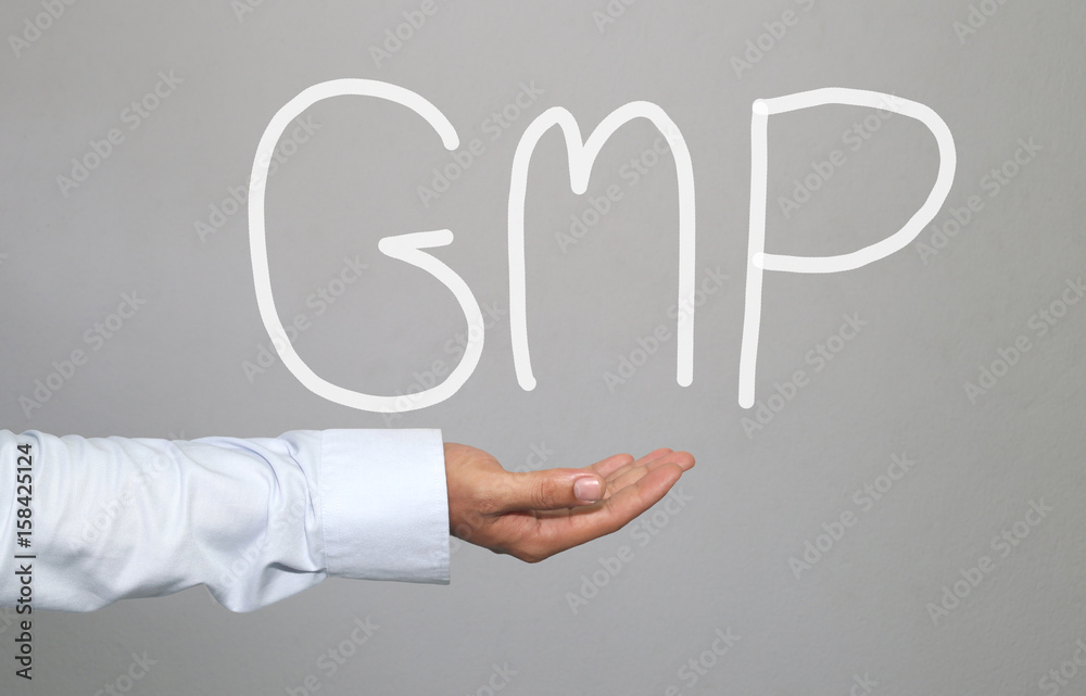 Hand of businessman and hand drawn text GMP system. Hand of businessman and hand drawn text GMP system.