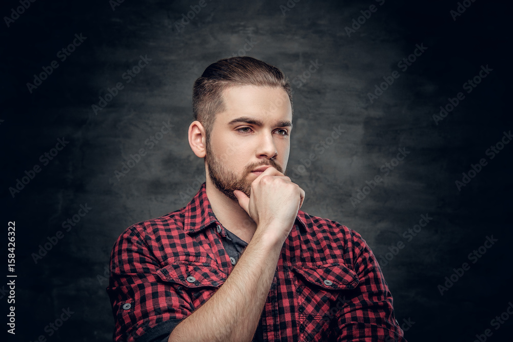 Thoughtful bearded male dressed in a red fleece shirt. Thoughtful bearded male dressed in a red fleece shirt.