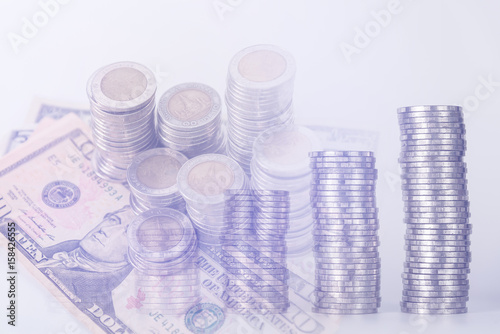 Double exposure of piles of coins dollar currency and account book with calculator on white background