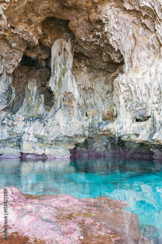 Calm turquoise colored water in pool in limestone cave on Avaiki coast of Niue.
