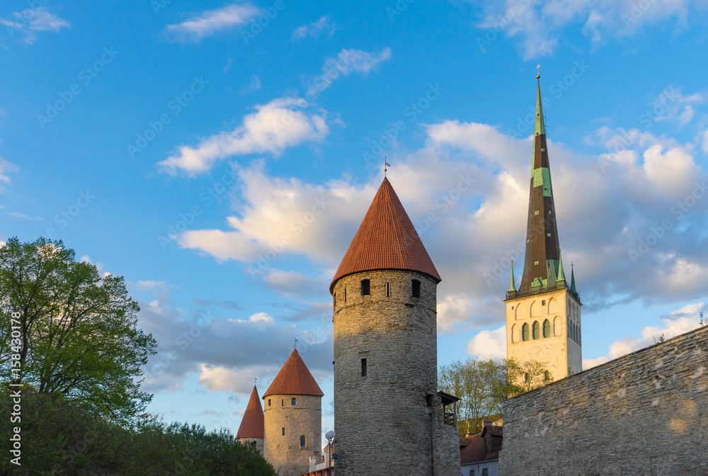 Fortress towers and St. Olaf's church against blue sky and clouds