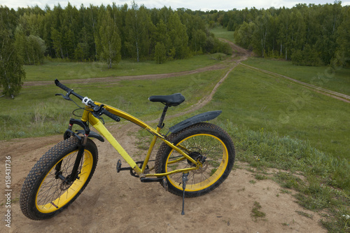 Fat bike at summer countryside - dirty bicycle, horizontal