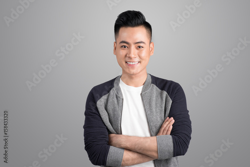 Portrait of cool handsome asian man with arms crossed