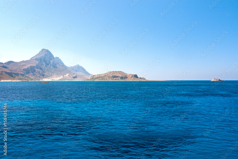 The calm sea with a mountain coast in the northwest of Crete, Greece