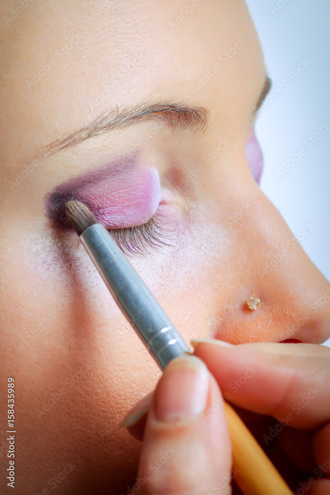Makeup. Make-up Applying closeup. Eyeliner. Cosmetic Eyeshadows. Eyeline brush for Make up