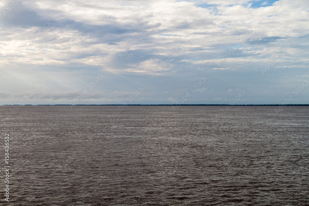 Cloudy sky and Amazon river, Brazil