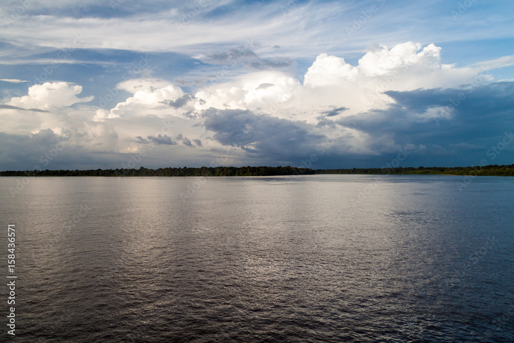 Obraz premium Cloudy sky and Amazon river, Brazil