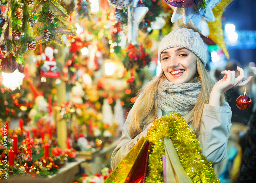 Portrait of young positive cheerful  woman at Christmas fair