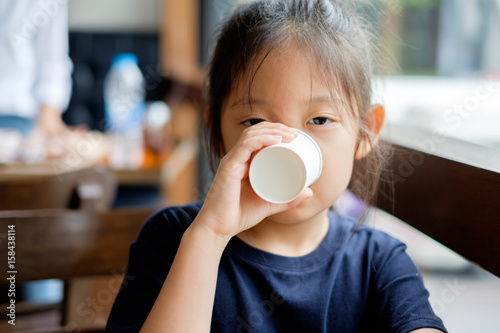 Asian Child Drinking Water from Paper Cup