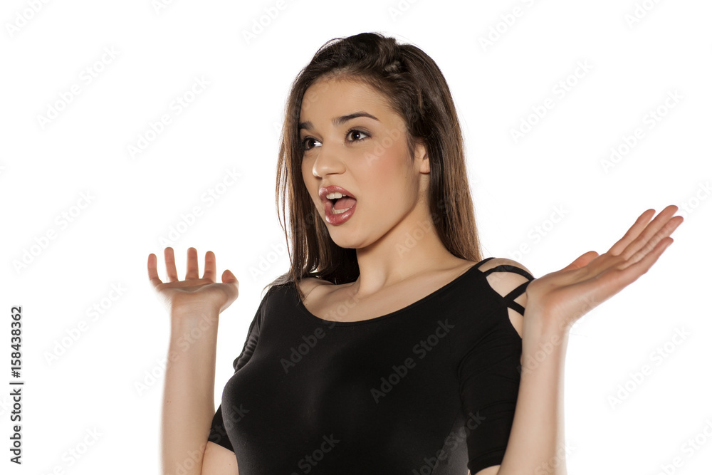 A young surprised girl on a white background