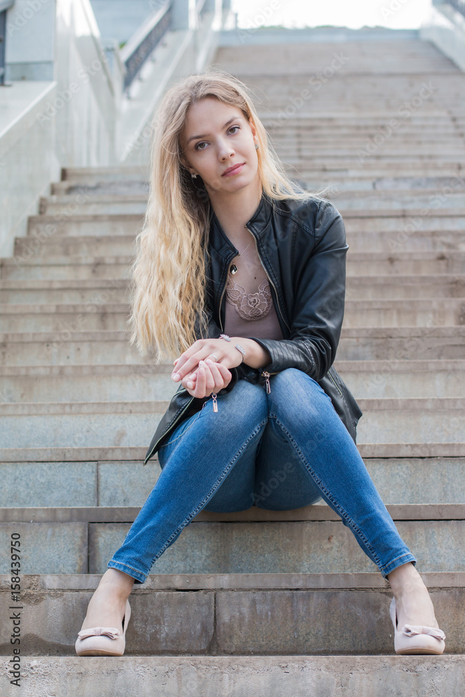 Girl with blond hair on the stairs Girl with blond hair on the stairs