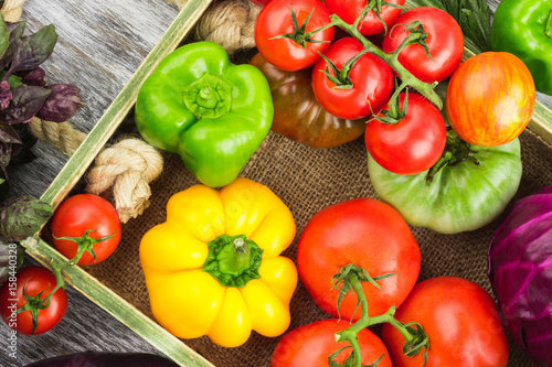 Set of raw vegetables in the wooden tray