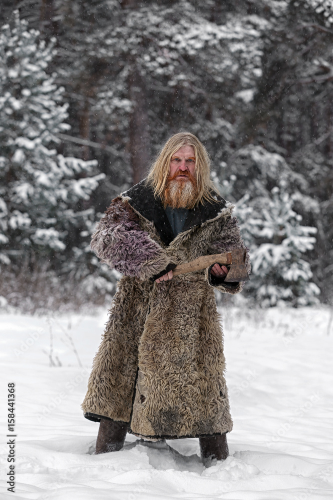 Lumberjack in the winter pine forest Lumberjack in the winter pine forest