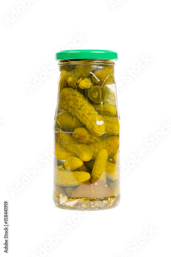 pickled cucumbers in glass jar isolated on white