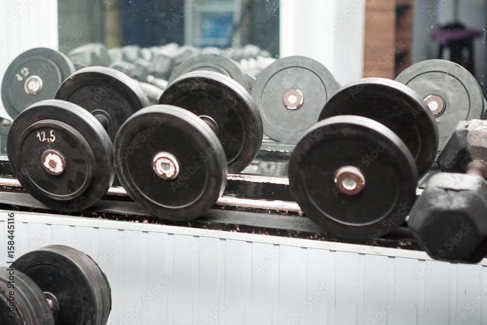 Fitness equipment in a gym. Workout and barbell Fitness equipment in a gym. Workout and barbell