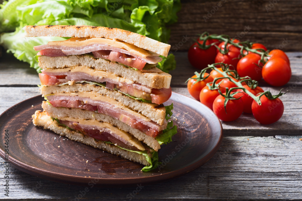 Club sandwich with bacon, tomato, cucumber and herbs Club sandwich with bacon, tomato, cucumber and herbs
