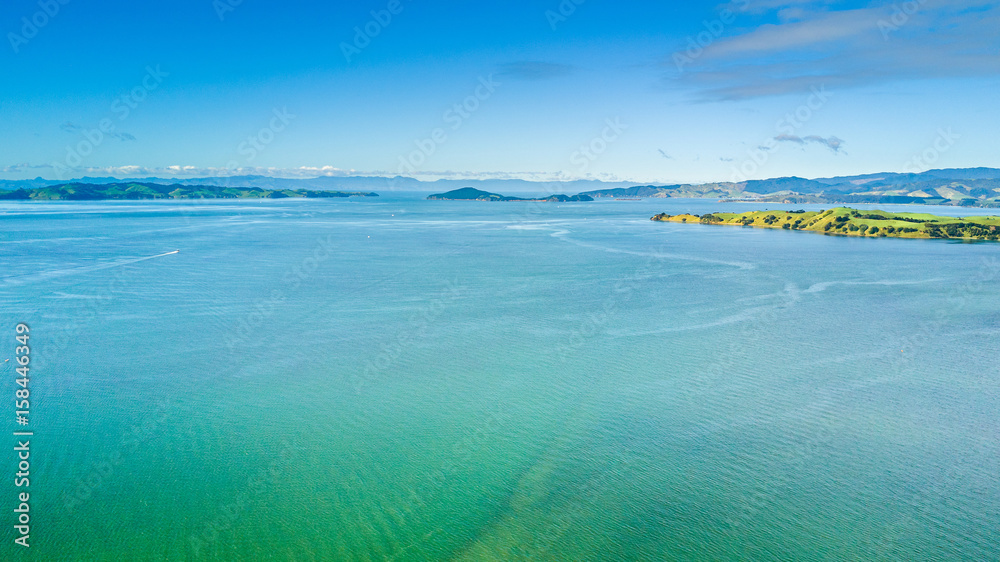 Aerial view on beautiful harbour with sunny beach and surrounding hillside, New Zealand