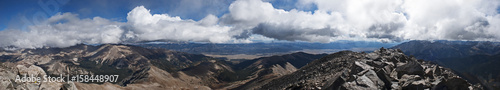 panorama of billowing clouds above rocks