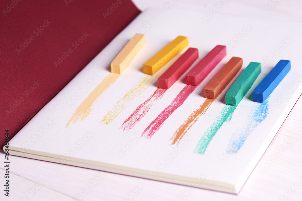 Sketch pad covered with colorful chalks Sketch pad covered with colorful chalks