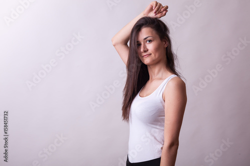 Gorgeous woman posing in studio on gray background. Sexy lady. Perfect beautiful attractive female posing in model test in studio