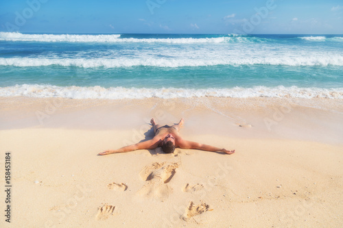 Man enjoying on empty tropical exotic beach.