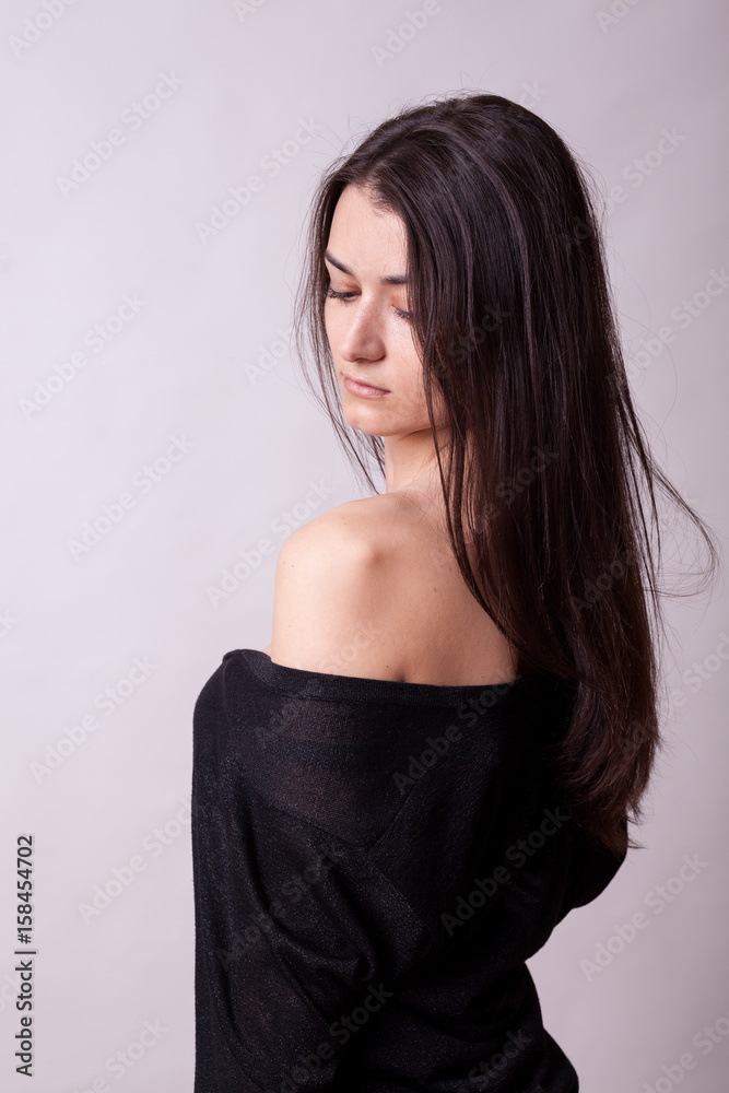 Naklejka premium Beautiful woman on gray background. Sexy lady. Perfect beautiful attractive female posing in model test in studio