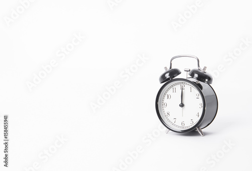 black alarm clock isolated on white table background and reflect.