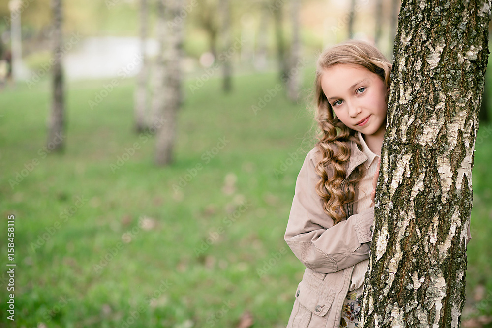 portrait of beautiful girl standing close to tree portrait of beautiful girl standing close to tree