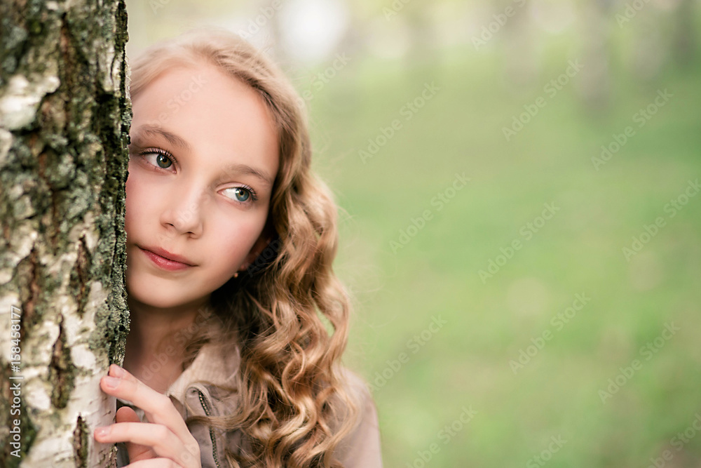 portrait of beautiful girl standing close to tree portrait of beautiful girl standing close to tree