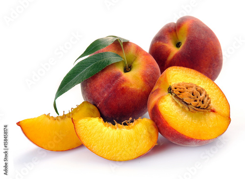 Fresh peach with green leaf isolated on white background