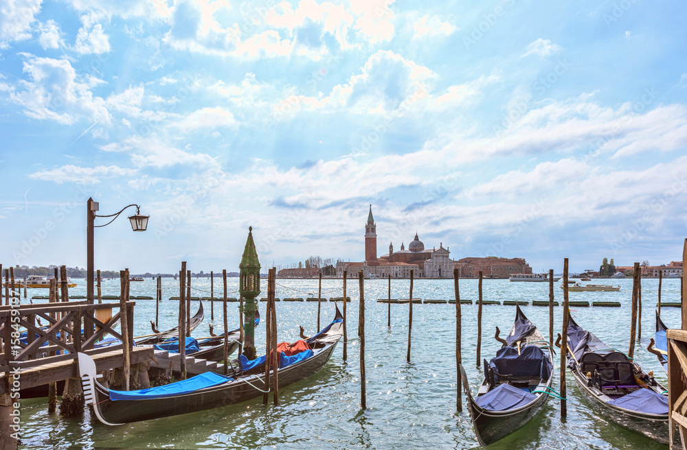 Grand canal in Venice, Piazza San Marco, in the background the island San Giorgio. Scenic moody cityscape with gondolas