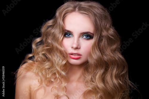 Beauty Fashion Model Woman , portrait, hairstyle with creative hair-dress, curls waves. Concept Girl face with perfect skin in dark Background