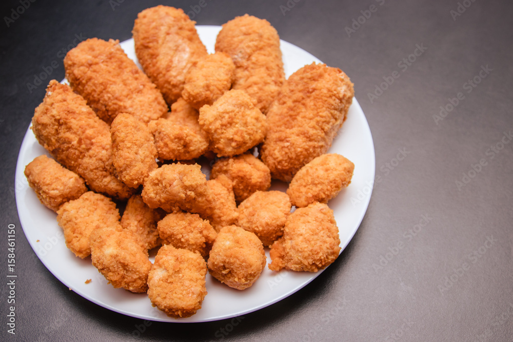 Cutlets in breading on a black background Cutlets in breading on a black background