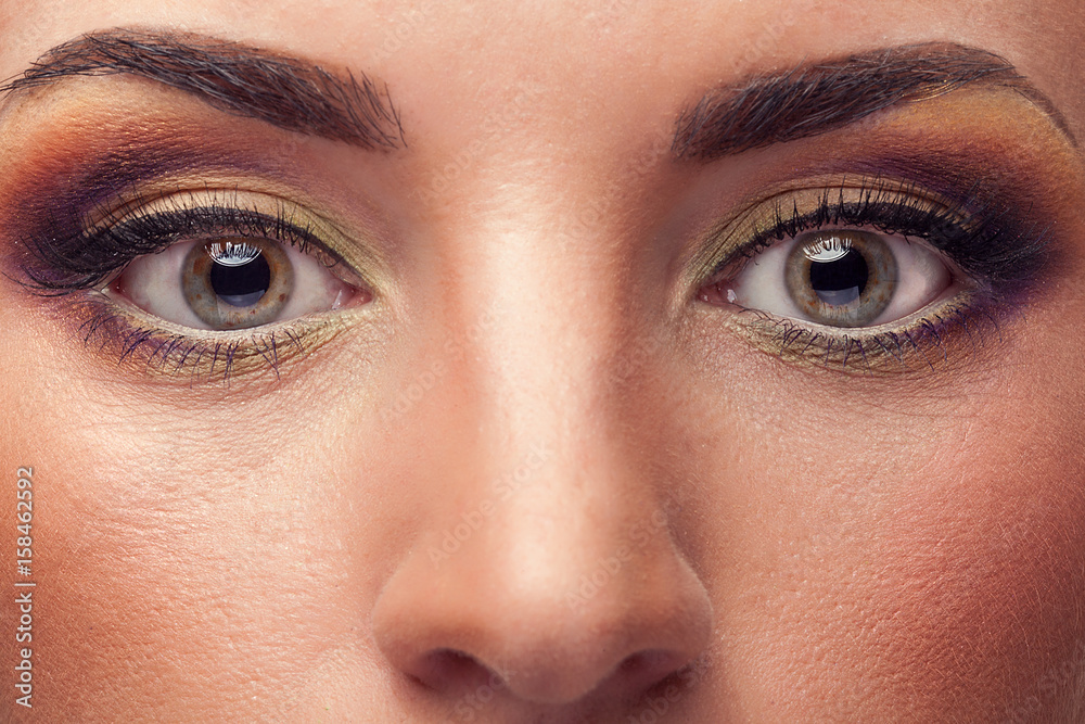 Fototapeta premium Close up face of woman wearing make up. Cosmetics and advertising. Beauty and makeup