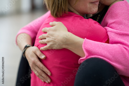 Two women are hugging