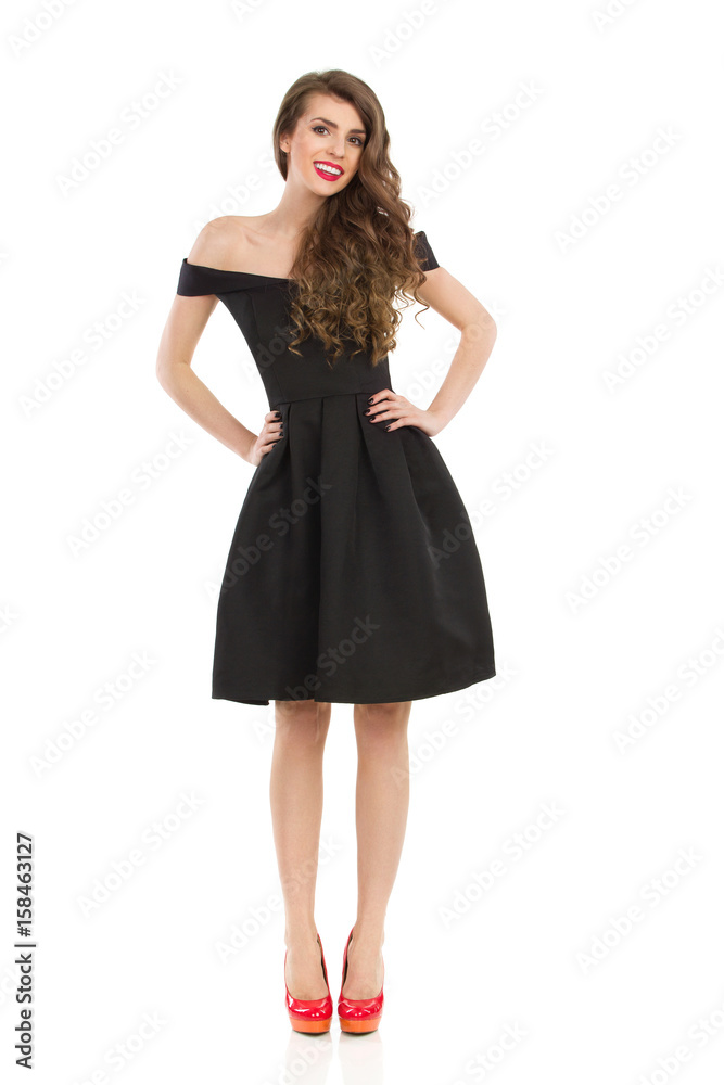 Elegant Woman In Black Dress Is Posing With Hands On Hip