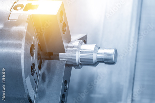 Photography The aluminium screw  thread on the CNC lathe or CNC turning in light blue scene