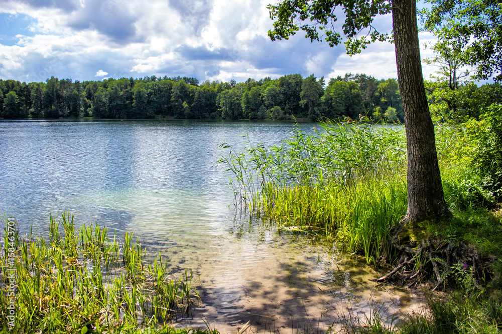 Landscape with beautiful pond in the summer - clear blue water and shore with sand. Landscape with beautiful pond in the summer - clear blue water and shore with sand.