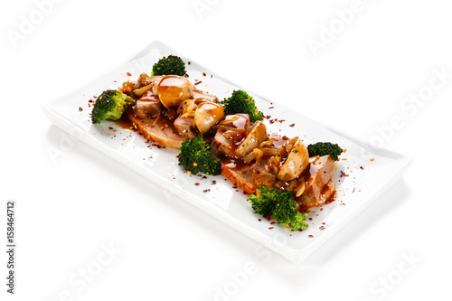 Grilled meat with broccoli and mushrooms on white background