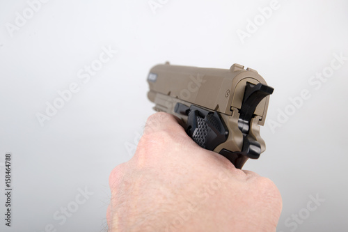 Hand holding modern air gun pistol