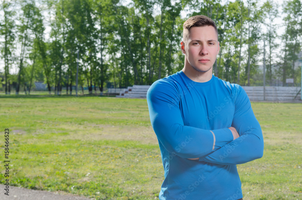 Fototapeta premium Young athlete with arms crossed at the stadium