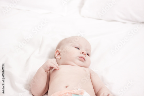 portrait of Cute baby in white bed