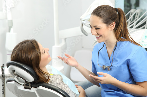 Dentist explaining procedure to a patient photo