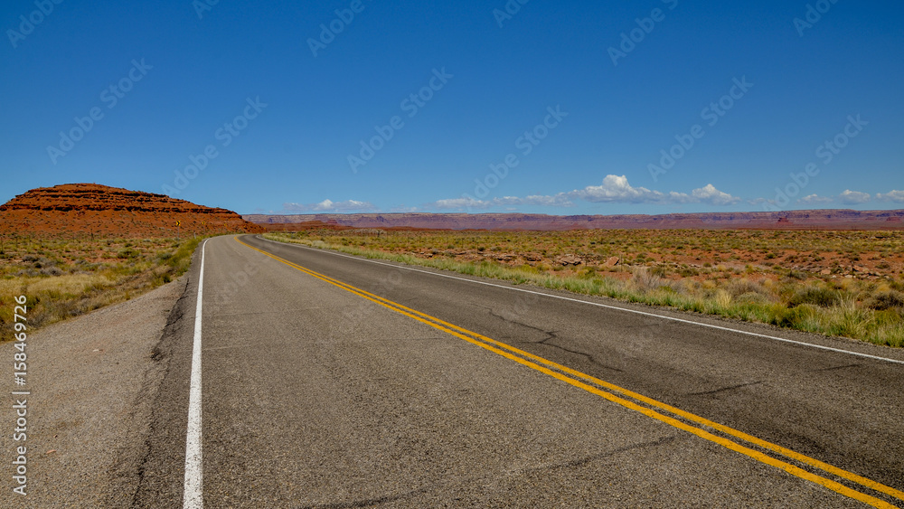 empty road in desert between Arizona and Utah 
U.S. Route 163 National Scenic Byway, Mexican Hat, San Juan County, Utah, United States