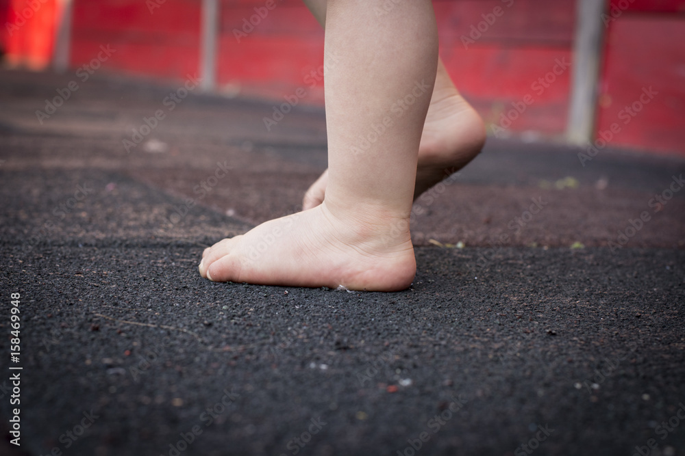 Child's feet on the floor. Baby first step. Child's feet on the floor. Baby first step.