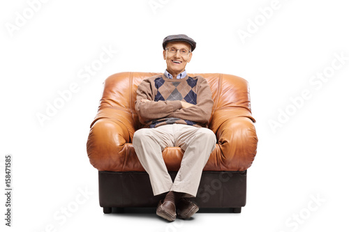 Elderly man sitting in a leather armchair