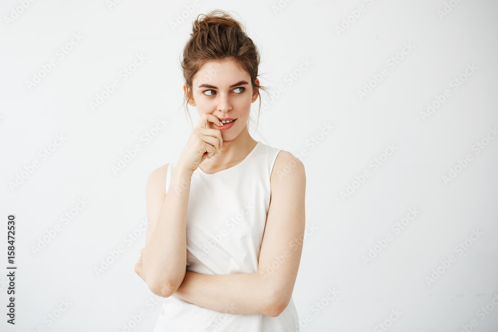 Portrait of young beautiful girl smiling thinking dreaming touching her chin over white background. Portrait of young beautiful girl smiling thinking dreaming touching her chin over white background.