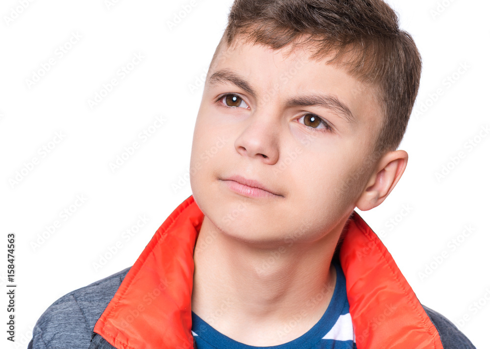 Close up emotional portrait of caucasian teen boy. Head shot of handsome guy. Funny cute teenager, isolated on white background. Child looking away.