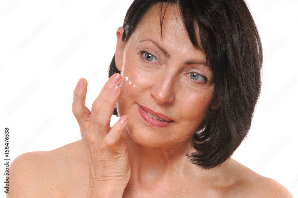 close up portrait of pretty senior woman using face cream close up portrait of pretty senior woman using face cream