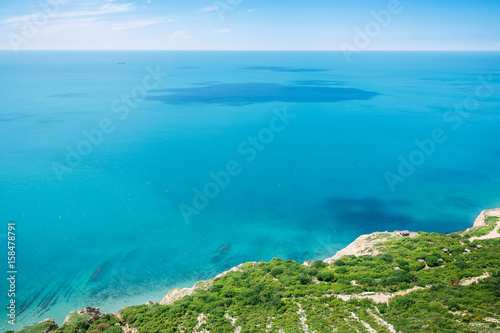 Blue sea, sky and rocks. Rocky coast on ocean. Summer in Greece